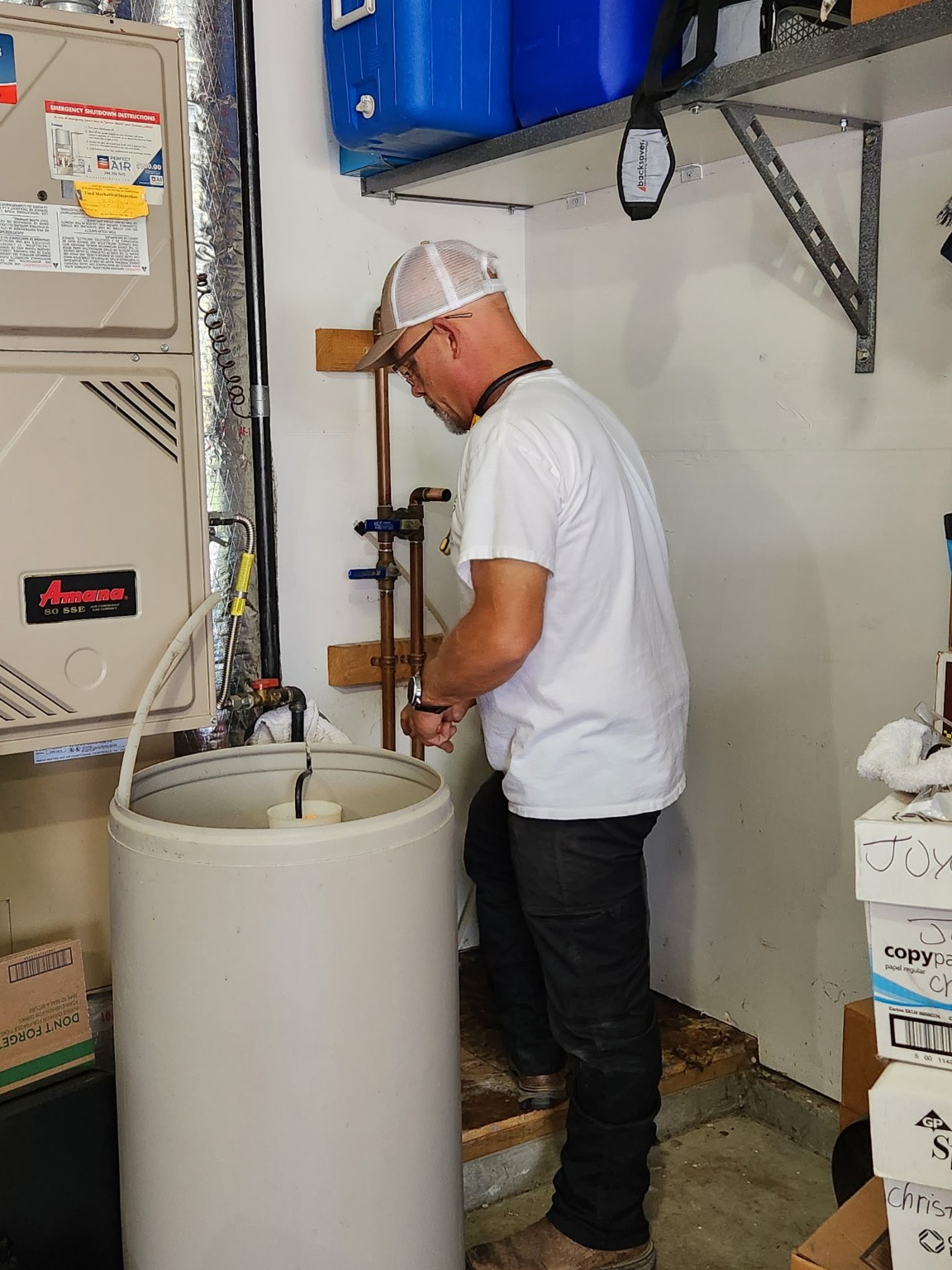 Farmer and Sons plumber servicing residential water equipment